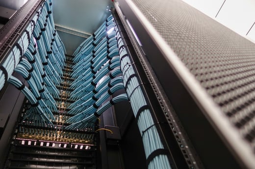 A detailed view of a data center server rack showcasing neatly organized cables.